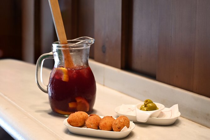Barcelona El Born Tapas and Wine Tour with Guide - Barceloneta-leaning Finale: Bomba Croquettes, Padron Peppers, and Dessert