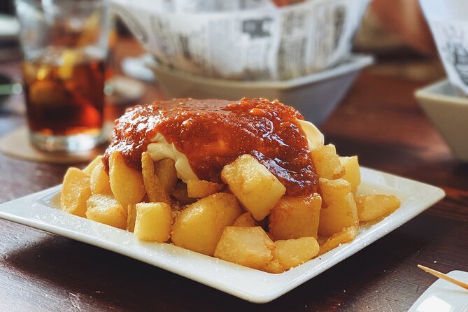 Barcelona Food Tour: Tapas, Drinks and Delights with a Local - Carrer del Regomir: pan con tomate, pimientos del padron, and tortilla with cava