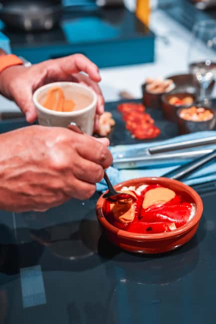 Madrid: Tapas Cooking Class with bottomless Wine Pairing - Finding the Cooking Clubhouse and Getting Settled With Cava